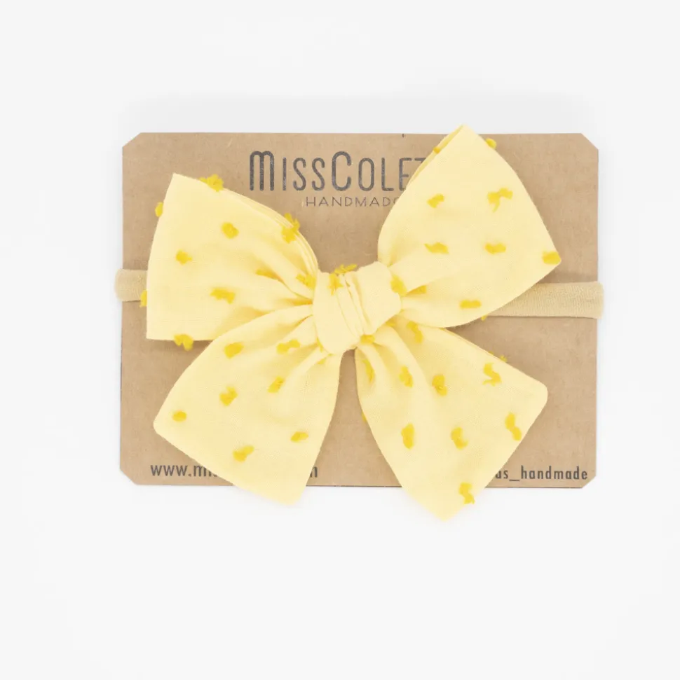 Diadema bebé lazo amarillo plumeti