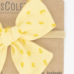 Diadema bebé lazo amarillo plumeti