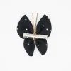 Pinza mariposa negra topos oro